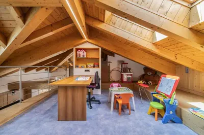 a room with a desk and chairs in a attic at Villa Azzurra, Cloz Ospitar in Cloz