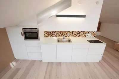 a kitchen with white cabinets and a sink at Weingut Griesserhof in Varna