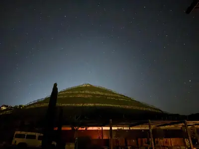 a building with a green roof under a night sky at Weingut Griesserhof in Varna