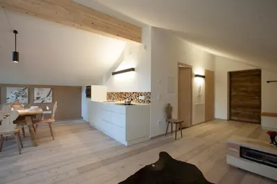 a kitchen and living room with a dog laying on the floor at Weingut Griesserhof in Varna