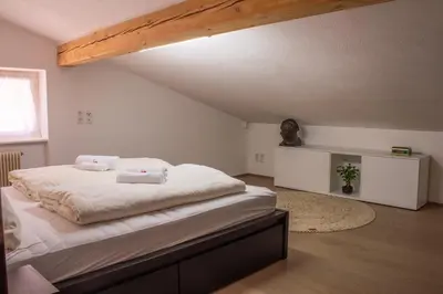 a bedroom with a bed with two towels on it at Lovely,cosy Apartment 2 Min Skilift Walk in Campitello di Fassa