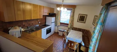 a kitchen with a sink and a counter top at Garofol da Mont-Dolomiti e Relax in Soraga
