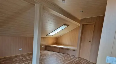an empty room with a skylight in a wooden ceiling at Chalet Corallo con camino e ingresso indipendente in Ronco