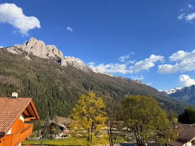 a view of a mountain with trees and houses at Casa mia - vall di fassa in Vigo di Fassa