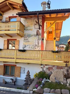 a house with a mural on the side of it at Casa mia - vall di fassa in Vigo di Fassa