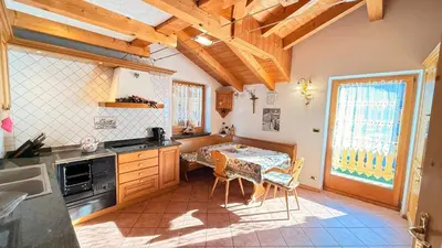 a kitchen with a table and chairs in a room at Casa mia - vall di fassa in Vigo di Fassa