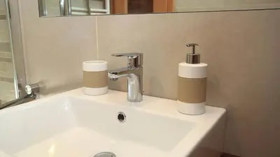 a bathroom sink with two paper towels and a faucet at Bed and Breakfast Iman in Santa Cristina in Val Gardena