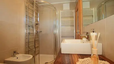 a bathroom with a shower and a sink and a tub at Bed and Breakfast Iman in Santa Cristina in Val Gardena