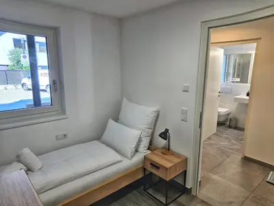 a small room with a couch and a window at Apartment Rosmarin - Alpstay in Naturno