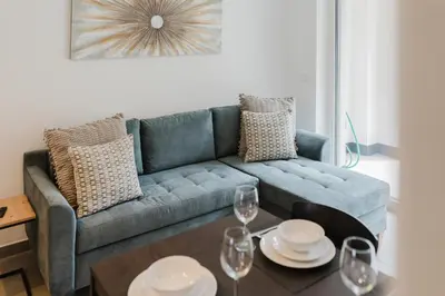 a living room with a blue couch and a table at Apartment Rosmarin - Alpstay in Naturno