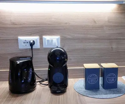 a black electric kettle and coffee maker on a table at Appartamento-Wohnung Amblar in Cavareno