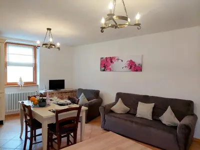 a living room with a couch and a table at Appartamento-Wohnung Amblar in Cavareno