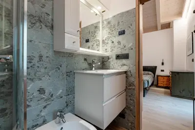 a bedroom with two beds and a window at Casa Pini By Go new location in Moena