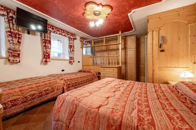 a bedroom with two beds in a room at Casa Pini By Go new location in Moena