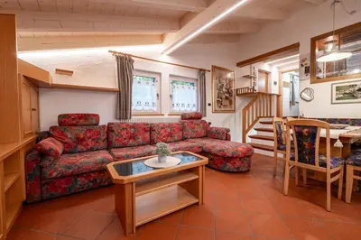 a kitchen with a washing machine and a window at Casa Pini By Go new location in Moena