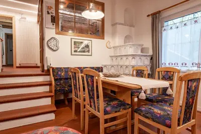 a kitchen with wooden cabinets and a stainless steel oven at Casa Pini By Go new location in Moena
