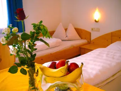 a bowl of bananas and apples on a table in a room at Gasthof Hohenbichl in Terento