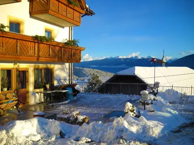 a house with snow on the ground in front of it at Gasthof Hohenbichl in Terento