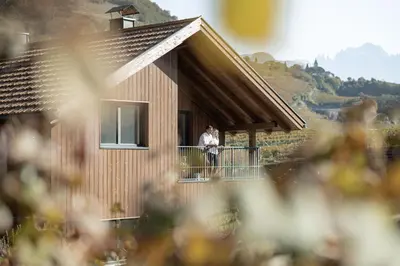 a man standing on a balcony of a house at Untermoserhof in Bolzano