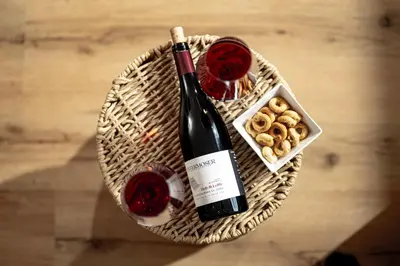 a bottle of wine and two glasses of red wine at Untermoserhof in Bolzano