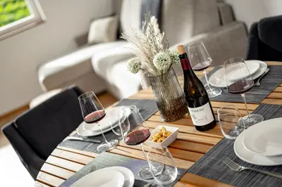 a table with a bottle of wine and glasses at Untermoserhof in Bolzano