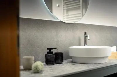a bathroom counter with a sink and a mirror at Untermoserhof in Bolzano