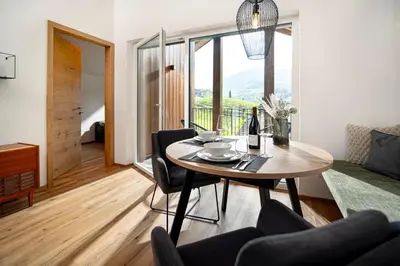a dining room with a table and chairs with a view at Untermoserhof in Bolzano