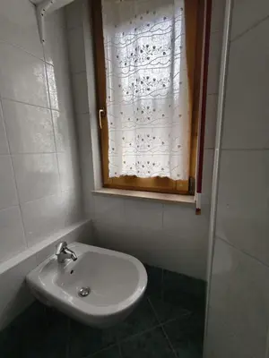 a bathroom with a sink and a window at Casa Roberta in Falcade