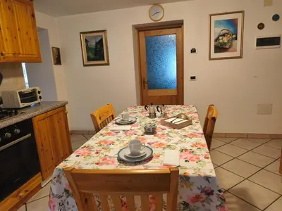 a kitchen with a table with a table cloth on it at Casa Roberta in Falcade