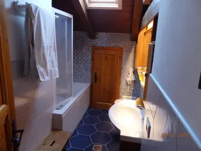 a bathroom with a toilet and a shower and a sink at Mansarda in chalet a Cortina in Cortina dʼAmpezzo