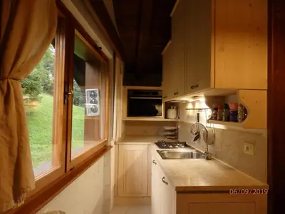 a small kitchen with a sink and a window at Mansarda in chalet a Cortina in Cortina dʼAmpezzo