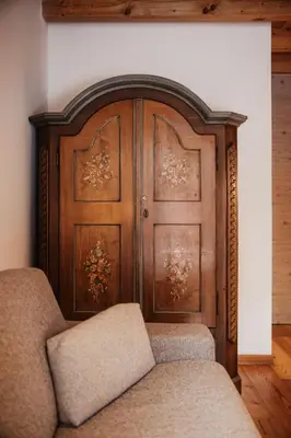a wooden door with two chairs in front of it at Stella Due in Arabba