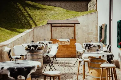 a patio with tables and chairs in front of a building at Stella Due in Arabba