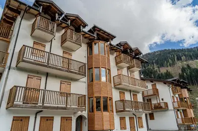 a building with balconies on the side of it at The Cutie Of Dolomites in Falcade