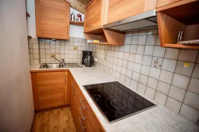 a small kitchen with wooden cabinets and a sink at Grossberghütte in Maranza