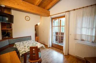 a living room with a table and a window at Grossberghütte in Maranza