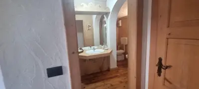 a bathroom with a sink and a mirror at La Dimora del Sole in Carano