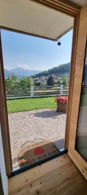 a view from a sliding glass door of a patio at La Dimora del Sole in Carano