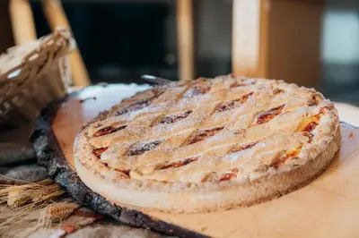 a pie sitting on top of a wooden table at Rifugio Bec de Roces in Pallua
