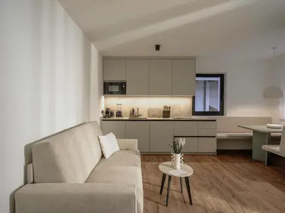 a living room with a couch and a kitchen at Dolomina in Funes