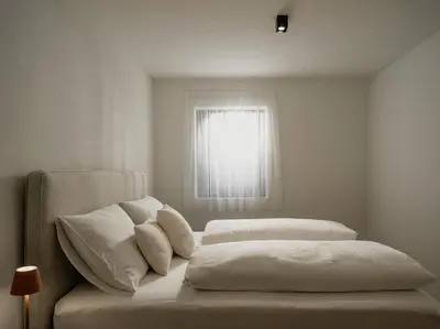 a bedroom with two beds and a window at Dolomina in Funes