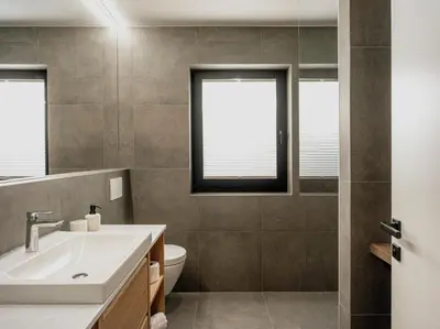 a bathroom with a sink and a toilet and a window at Dolomina in Funes