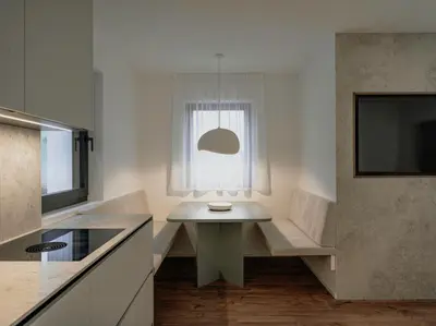 a kitchen with a white table and a window at Dolomina in Funes