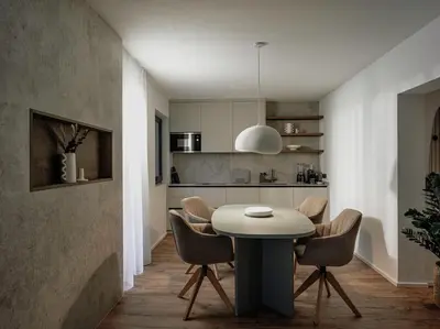 a kitchen and dining room with a table and chairs at Dolomina in Funes