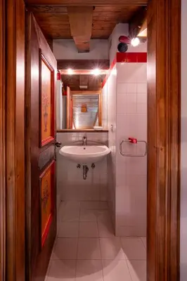a small bathroom with a sink and a shower at Spacious Alpine Loft with Stunning Antelao Views in San Vito di Cadore