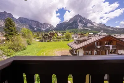 a view from the balcony of a house with mountains at Spacious Alpine Loft with Stunning Antelao Views in San Vito di Cadore