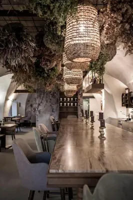a living room with a couch and a table with a plant at Bogen bistro & apartments in Bolzano