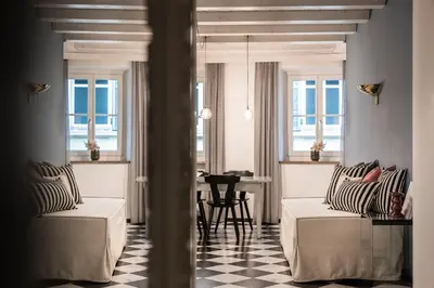 a bedroom with a bed and a table and chairs at Bogen bistro & apartments in Bolzano