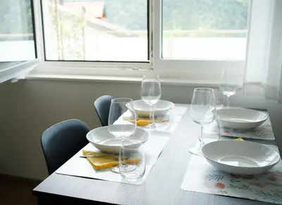 a table with glasses and plates on a table at Texlhof - Stella Alpina in Parcines