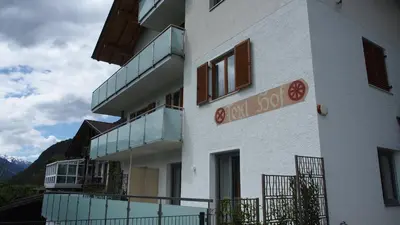 a white building with a sign on the side of it at Texlhof - Stella Alpina in Parcines